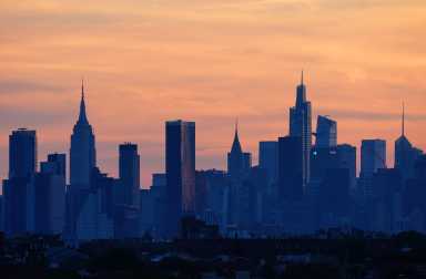 A general view as the sun sets behind the New York City skyline.