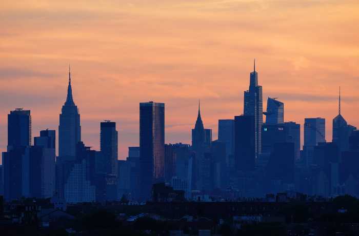 A general view as the sun sets behind the New York City skyline.