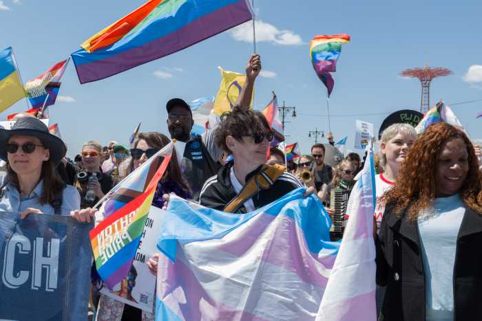 Marchers head east along the Riegelmann Boardwalk from Coney Island to Brighton Beach.