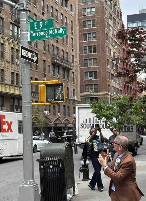 Tom Kirdahy applauds the new street sign.