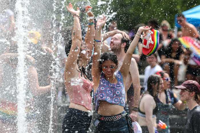 People dance in the Washington Square Park fountain after the 2025 NYC Pride March in New York City, U.S., June 29, 2025.
