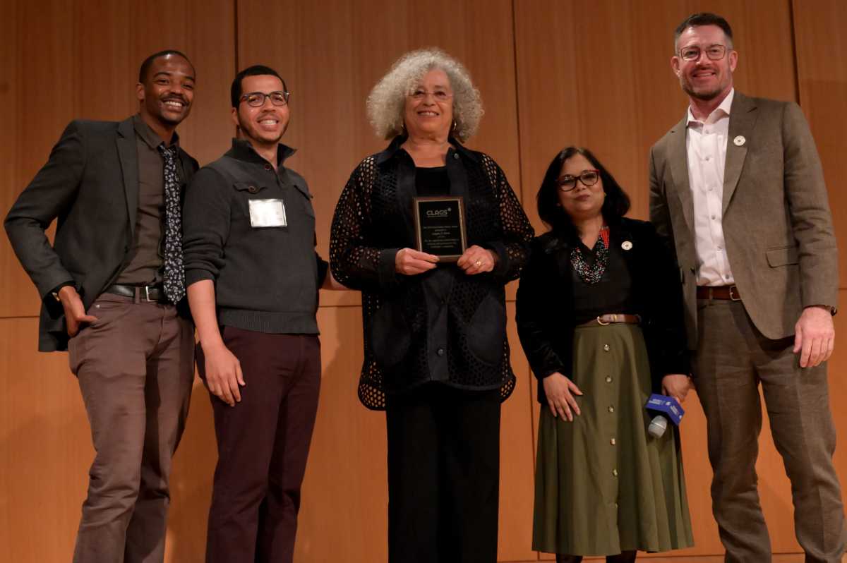 Angela Davis (center) accepts an award from CLAGS at the CUNY Graduate Center.