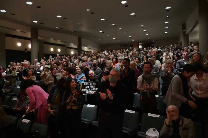 A packed audience applauds Angela Davis during the CLAGS event.