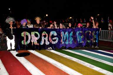 The Drag March banner leads the way.