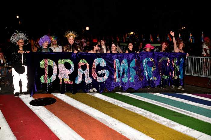 The Drag March banner leads the way.