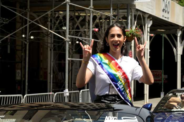 Grand marshal Elisa Crespo rides along the route.