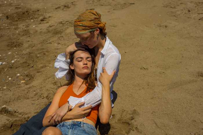 Ingrid (Vicky Krieps) holding Sofia (Emma Mackey) in "Hot Milk."
