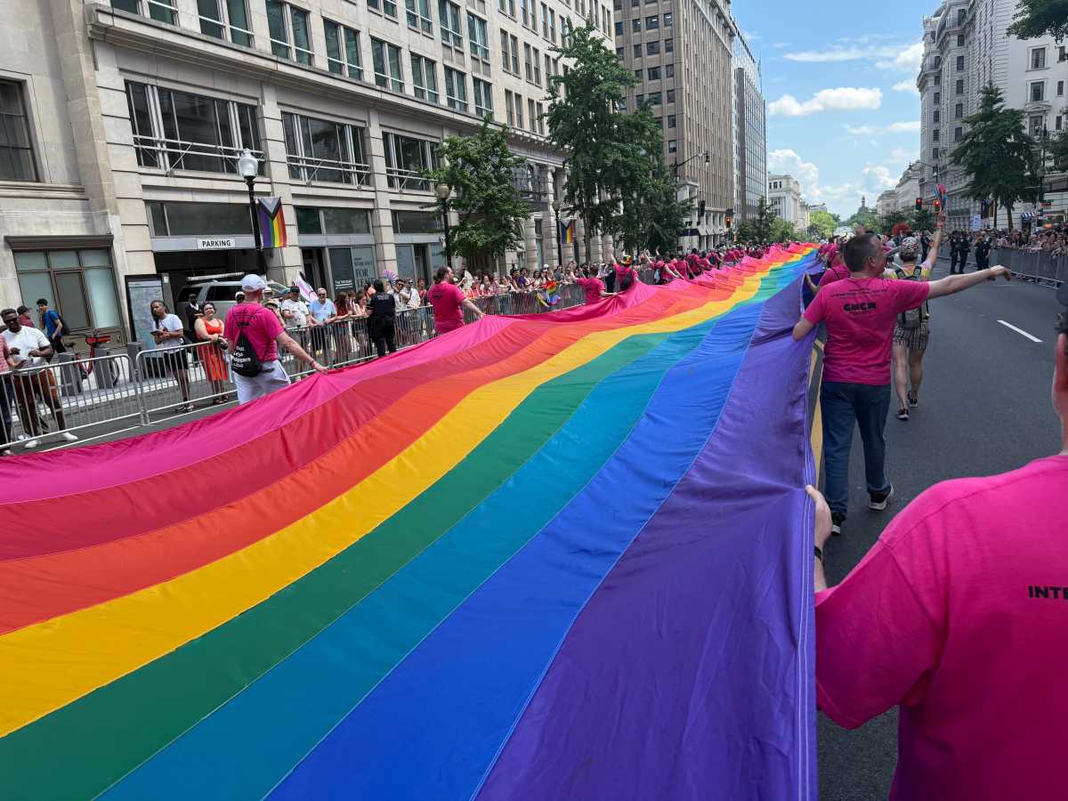 The late Gilbert Baker's long Rainbow Flag stretches through the streets of Washington.