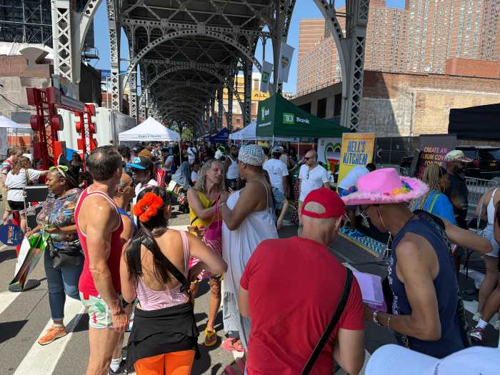 The crowd at Harlem Pride enjoys the atmosphere alongside tents featuring resources, food, and more.