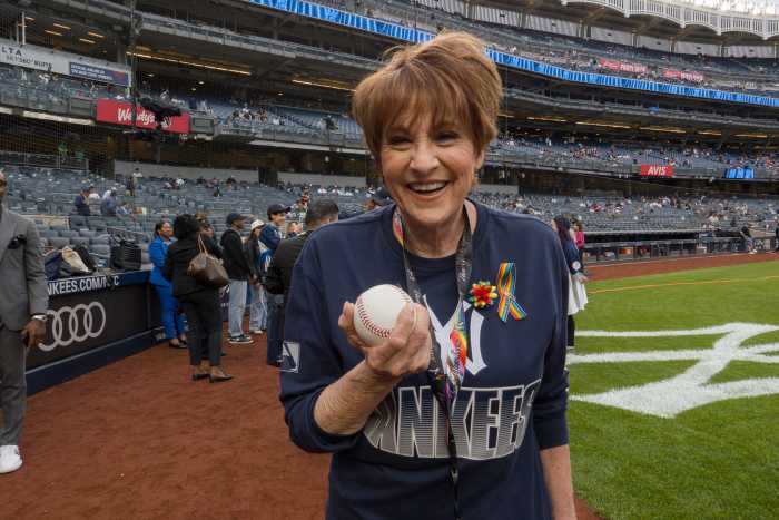 Actress and singer Lorna Luft holds the ball she used to throw out the first pitch.