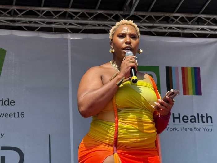 Nala S. Toussaint delivers remarks on stage.