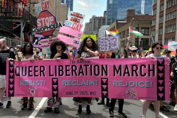 The 2025 Queer Liberation March banner leads the way.
