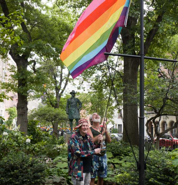 Randy Wicker (left) and Steven Love Menendez Raising the Rainbow Flag on federal land at the Stonewall National Monument.