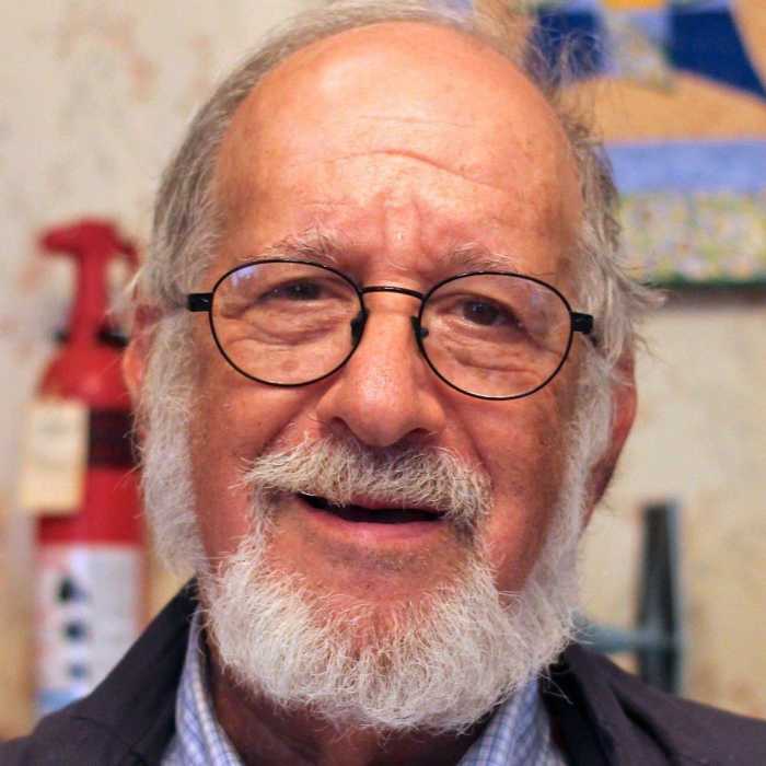 Hal Weiner faces the. camera in a close-up shot.