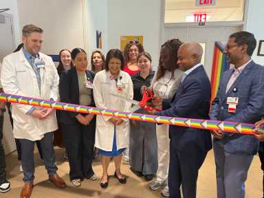 NYC H+H/Metropolitan CEO Julian John cuts the ribbon to mark the relaunch of the Pride Health Center.