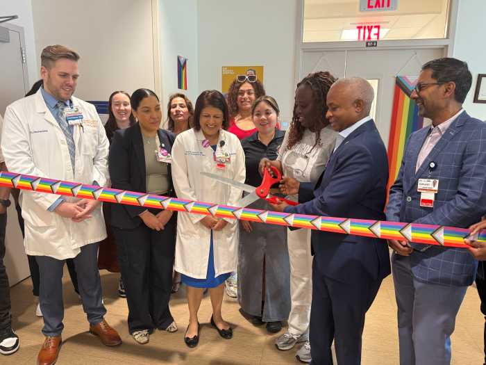 NYC H+H/Metropolitan CEO Julian John cuts the ribbon to mark the relaunch of the Pride Health Center.