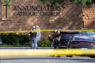 Law enforcement officers set up barriers after a shooting at Annunciation Church, which is also home to an elementary school, in Minneapolis, Minnesota, U.S. August 27, 2025.