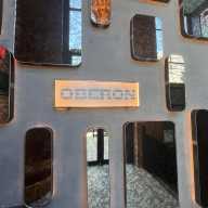 Upon entering Oberon, patrons are greeted by a collection of mirrors and a sign introducing the space.