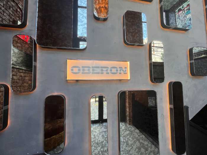 Upon entering Oberon, patrons are greeted by a collection of mirrors and a sign introducing the space.