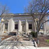 The front of a white brick building representing the Middletown Police Department on a sunny day.