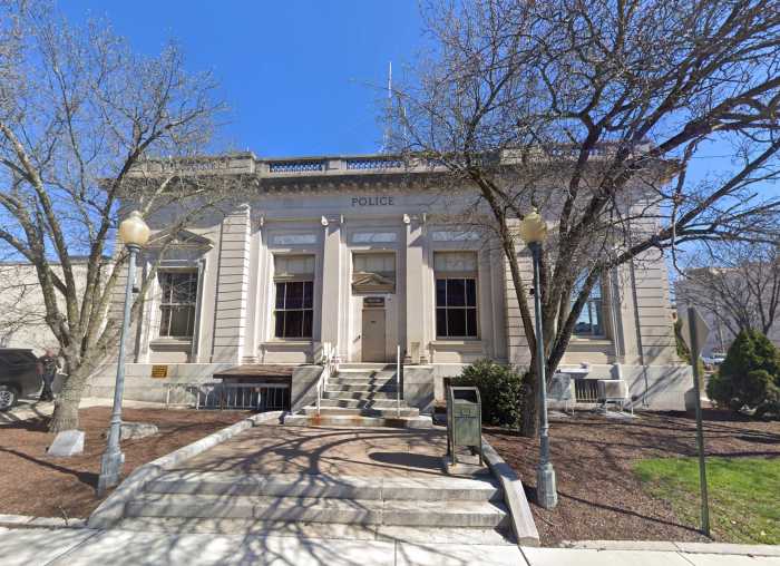 The front of a white brick building representing the Middletown Police Department on a sunny day.