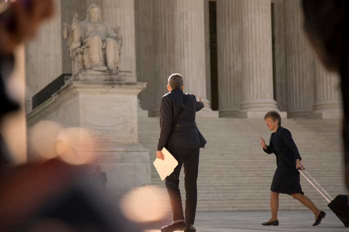 Mary Bonauto (with suitcase) gives the thumbs up to Mary Breslauer as she enters the Supreme Court for oral arguments in Obergefell v. Hodges on April 28, 2015. 