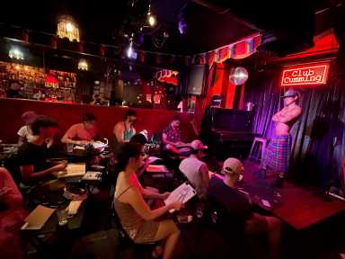 Artists sketch while a model poses during The Anatomy Lesson, a drink & draw event at Club Cumming.
