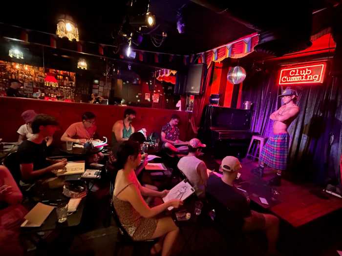 Artists sketch while a model poses during The Anatomy Lesson, a drink & draw event at Club Cumming.