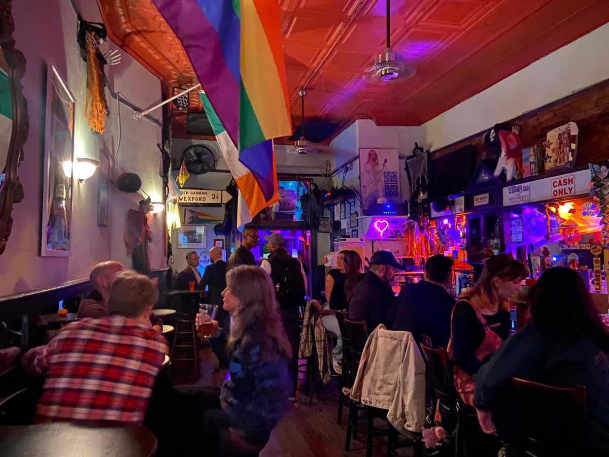People sit near the bar at Ginger's during a National Coming Out Day mixer on Oct. 9.