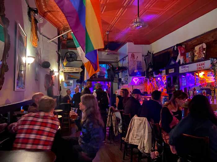 People sit near the bar at Ginger's during a National Coming Out Day mixer on Oct. 9.