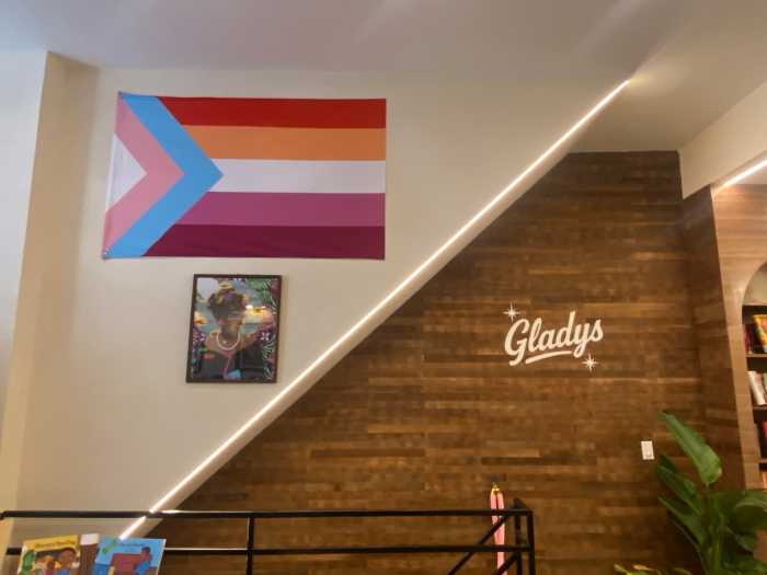 A Lesbian and Transgender Flag Hangs Above a Portrait of Marsha P. Johnson.