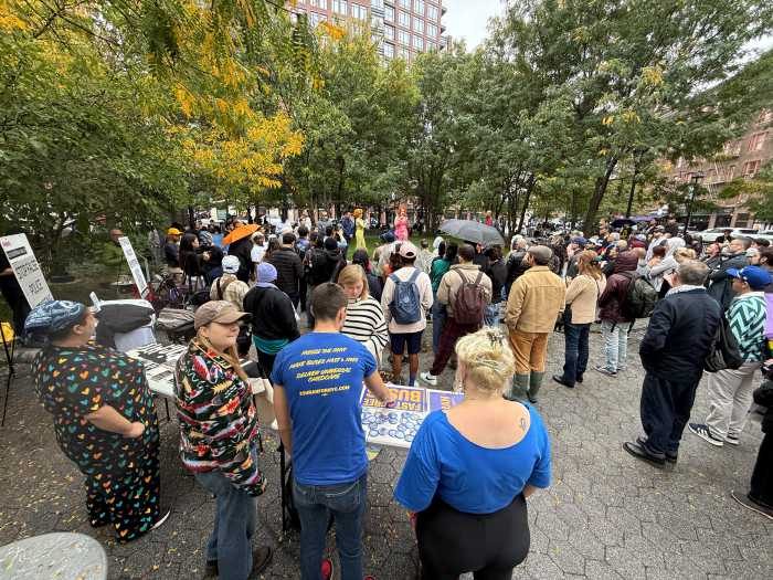The crowd gathers around the rally at the NYC AIDS Memorial.
