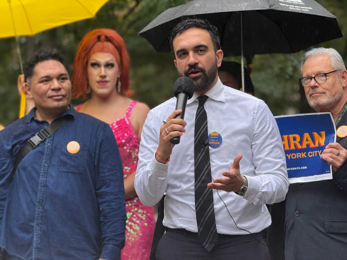 Zohran Mamdani, wearing a "Gays for Zohran" pin, delivers remarks to the crowd at a National Coming Out Day rally on Oct. 11.