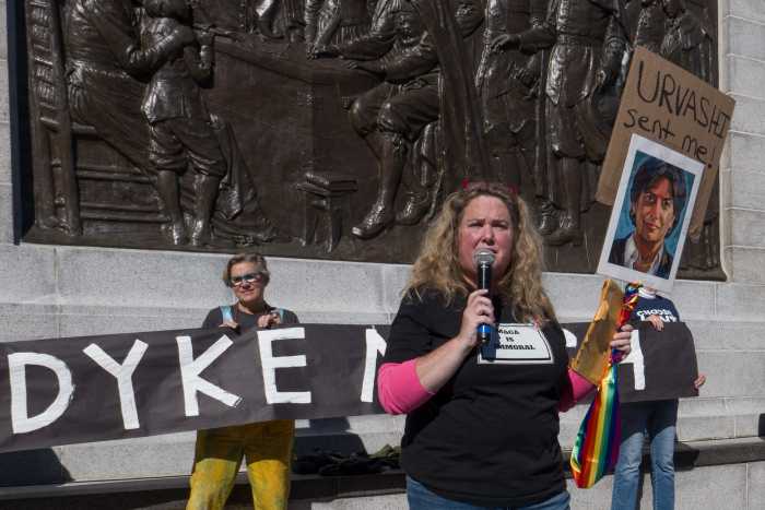 Michelle Axelson, organizer and owner of WomenCrafts, delivers remarks at the "No Kings" rally.