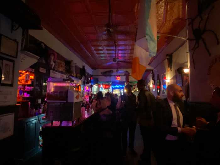 People Chatting by the Bar