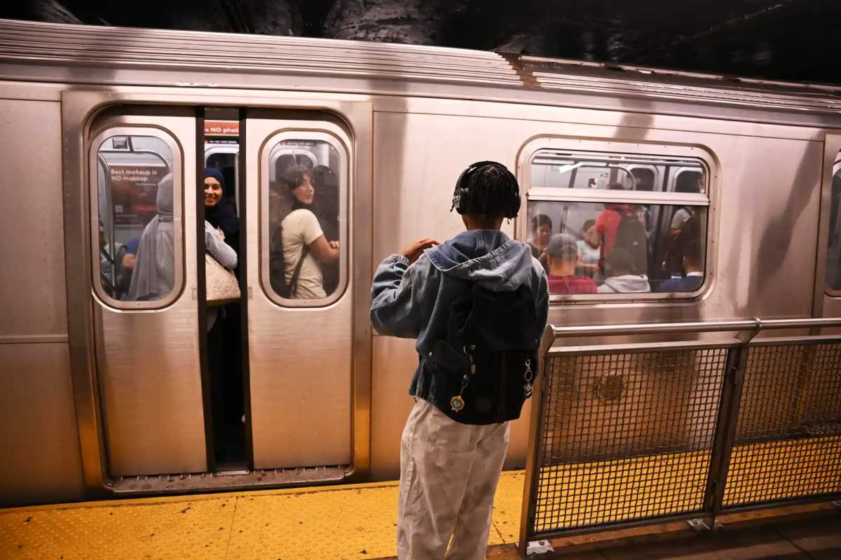 Students take the L train on their first day back to school on Sept 4.