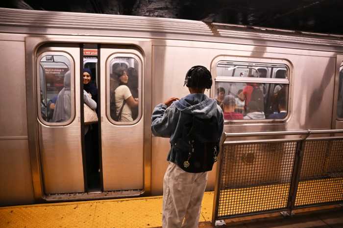 Students take the L train on their first day back to school on Sept 4.