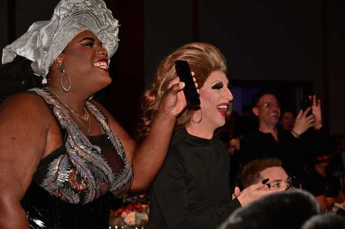 Qween Jean and Marti Gould Cummings cheer on from the audience.