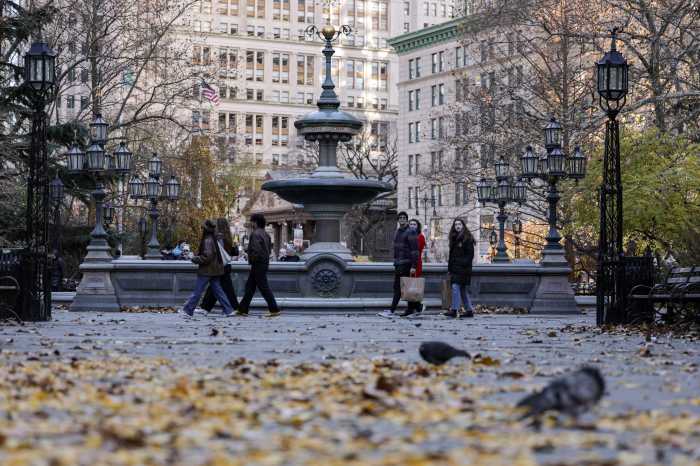 People walk past City Hall Park in New York City, U.S., November 28, 2025.