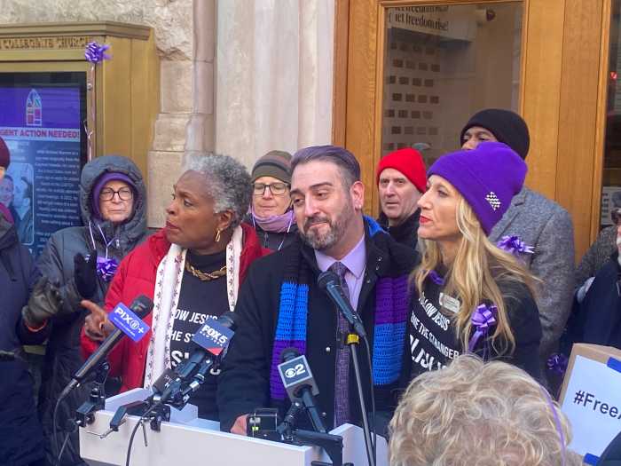 Rev. Jacqueline J. Lewis, Matthew Marrero, and Rev. Amanda Ashcraft sing a hymn together at a press conference on Dec. 9.