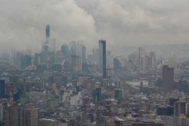 Fog clears to reveal the Manhattan Bridge and the Manhattan and Brooklyn skylines, as seen from the Edge NYC, in New York City, U.S., December 29, 2025.