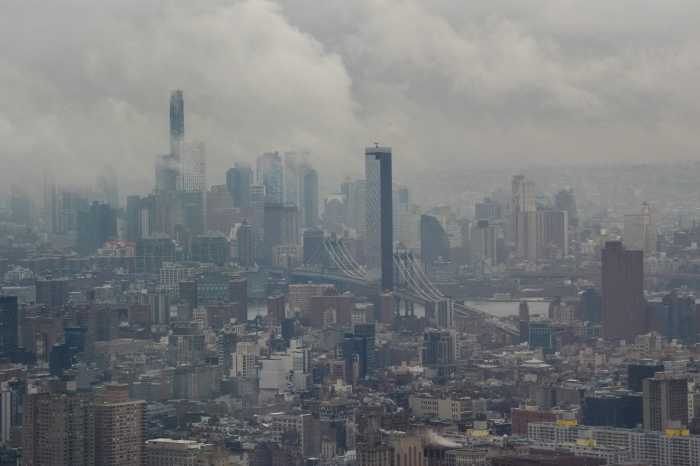 Fog clears to reveal the Manhattan Bridge and the Manhattan and Brooklyn skylines, as seen from the Edge NYC, in New York City, U.S., December 29, 2025.