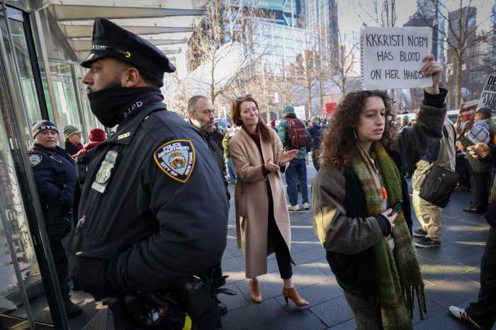 An anti-U.S. Immigration and Customs Enforcement (ICE) protestor holds a sign as protestors picket outside One World Trade Center, where U.S. Homeland Security Secretary Kristi Noem was holding a press conference in Manhattan in New York City, U.S., January 8, 2026.