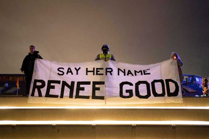 Attendees hold a banner bearing the name of Renee Nicole Good, who was shot and killed by a U.S. Immigration and Customs Enforcement (ICE) agent, during a vigil for her in Seattle, Washington, U.S. January 8, 2026.