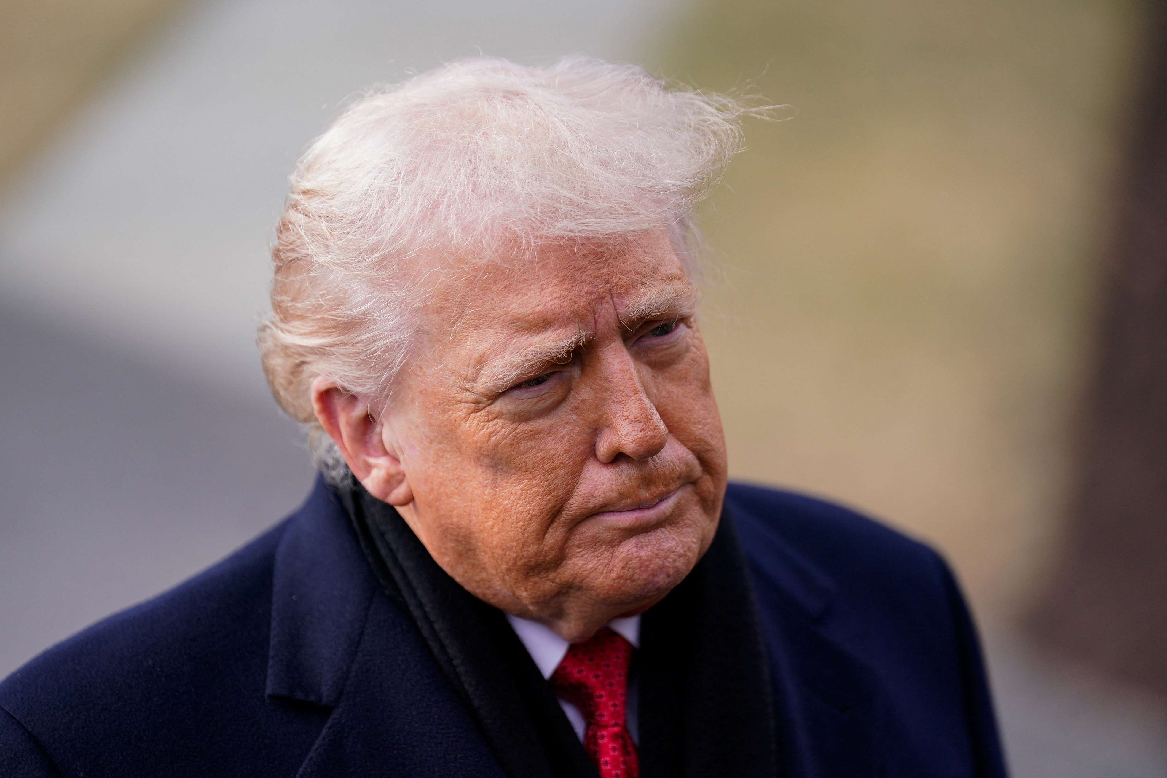 US President Donald Trump looks on before departing for Florida from the South Lawn, at the White House in Washington, D.C., U.S., January 16, 2026.