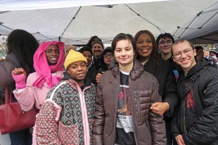 Rally organizers and speakers stand with Attorney General Letitia James.