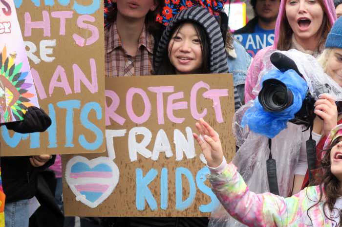 People of all ages brave the rainy conditions to support trans youth.