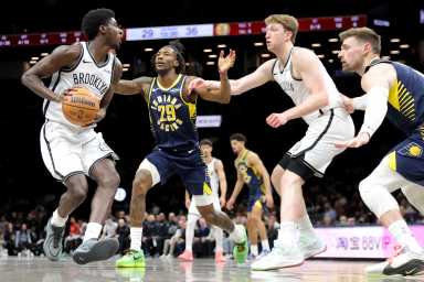 Feb 11, 2026; Brooklyn, New York, USA; Brooklyn Nets guard Drake Powell (4) looks to pass the ball against Indiana Pacers guard Quenton Jackson (29) and center Micah Potter (11) during the second quarter at Barclays Center.