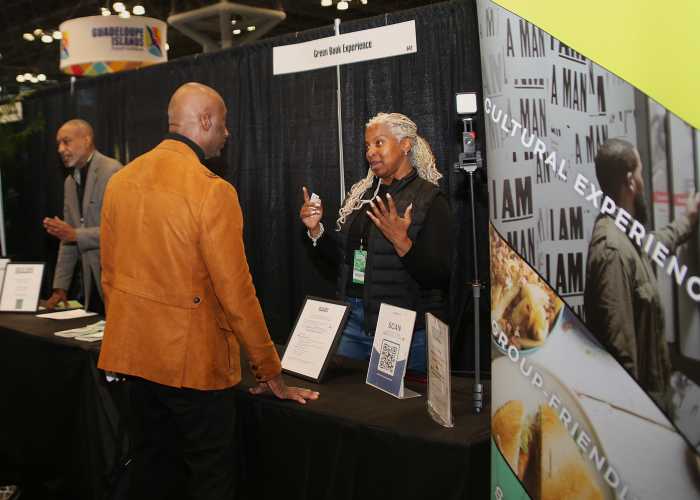 Karen Aaron of the Green Book Experience talks to a visitor during the New York Travel and Adventure Show. 