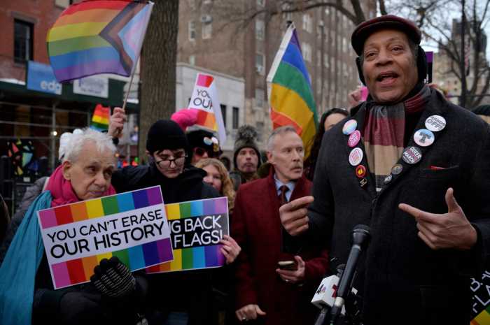 Jay W. Walker, flanked by LGBTQ activists, leads the Feb. 10 rally at Christopher Park.